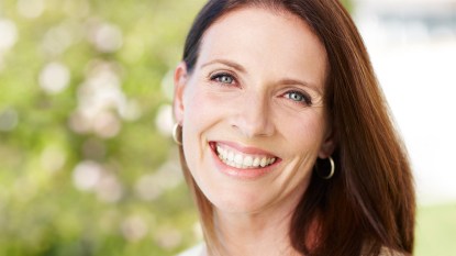 Woman smiling with glowing skin after using one of the best toners