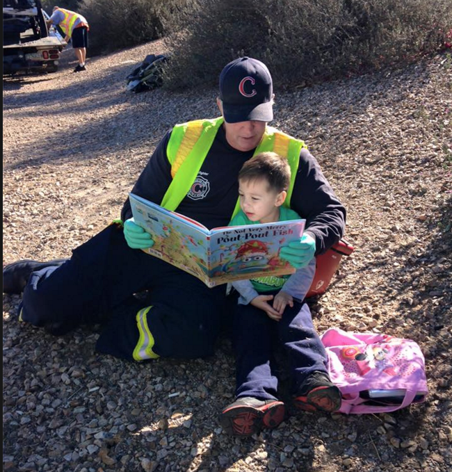 Firefighter Reads to Kid