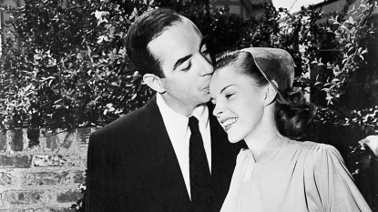 Film director Vincente Minnelli kisses singer and actress Judy Garland on the brow at their wedding, 1945 classic stars who were married several times