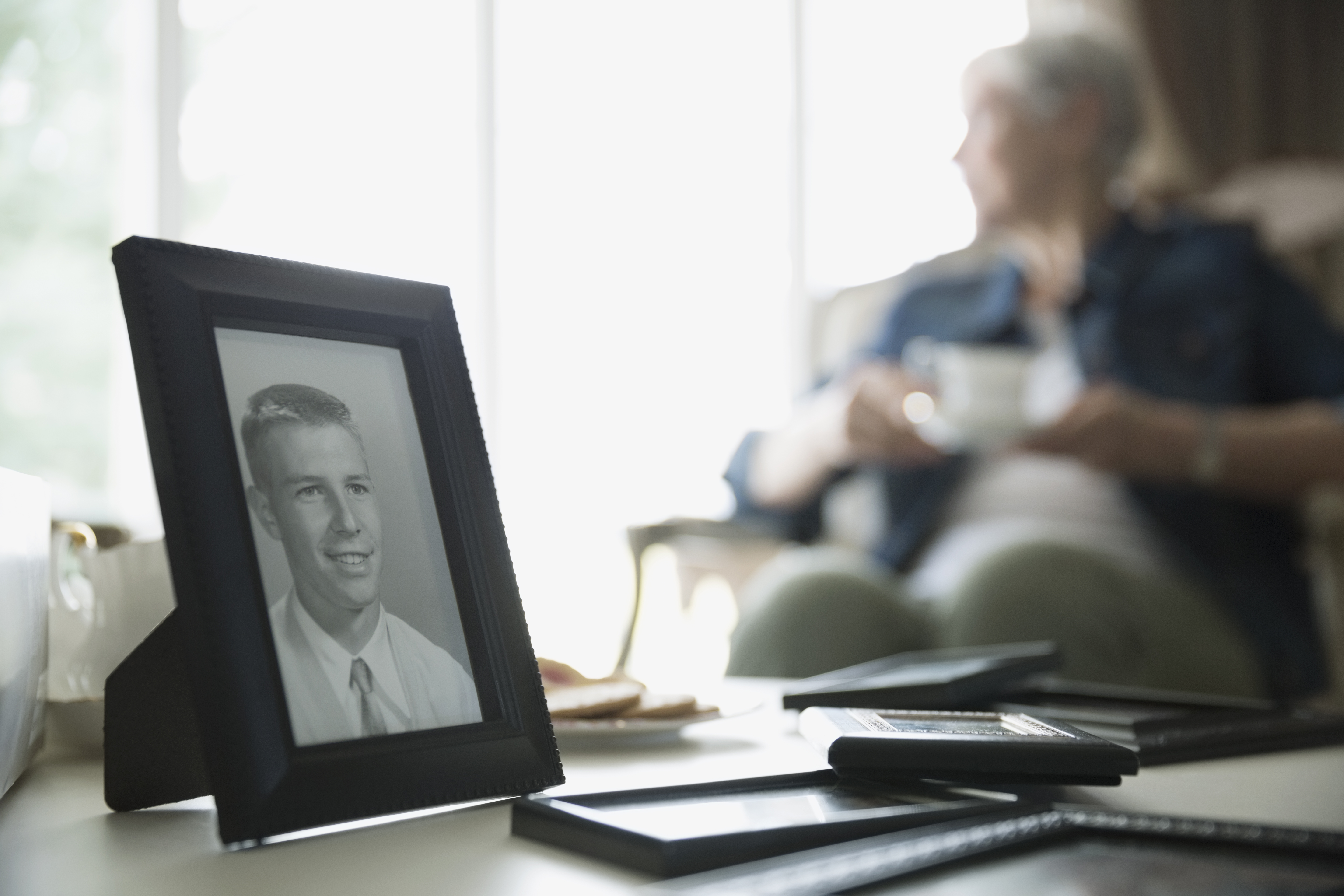 Old Woman with Photo of Young Man