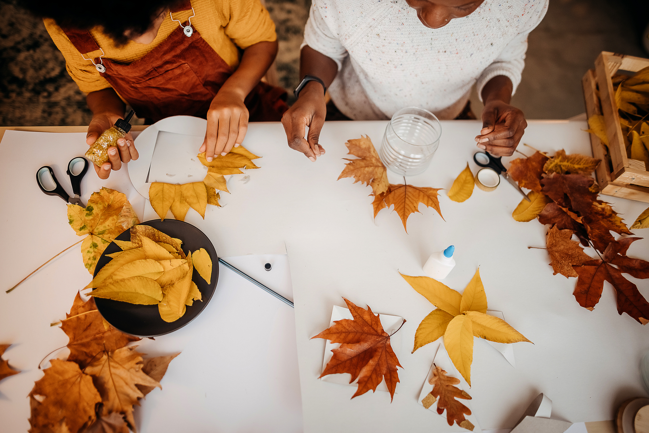 Mother and daughter make autumn decoration at home