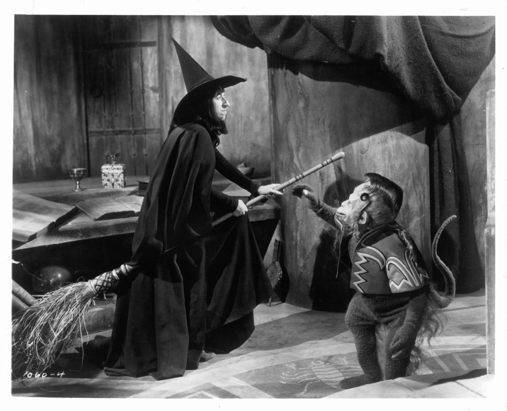 Margaret Hamilton as the Wicked Witch of the West gets ready to fly away as one of her flying monkey's reaches for her in a scene from the film 'The Wizard Of Oz',(Wizard of Oz behind the scenes)