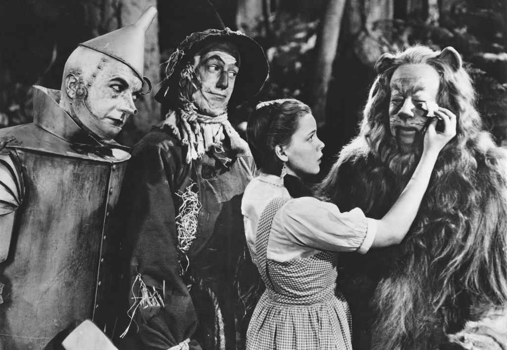 From left to right, Jack Haley as the Tin Man, Ray Bolger as the Scarecrow, Judy Garland as Dorothy and Bert Lahr as the Cowardly Lion in the MGM film 'The Wizard of Oz', 1939. (Wizard of Oz behind the scenes)