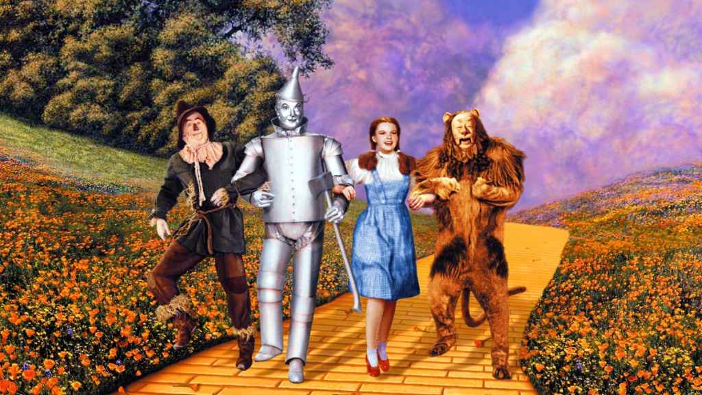 Ray Bolger (1904-1987), US actor, Jack Haley (1897-1979), US actor, Judy Garland (1922-1969), US actress and singer, and Bert Lahr (1895-1967), US actor and comedian, all in costume as they dance along the yellow brick road in a publicity still from the film, 'The Wizard of Oz', 1939. The musical, adapted from the novel by L Frank Baum (1856-1919) and directed by Victor Fleming (1889-1949), starred Bolger as the 'Scarecrow', Haley as the 'Tin Man', Garland as 'Dorthy Gale', and Lahr as the 'Cowardly Lion