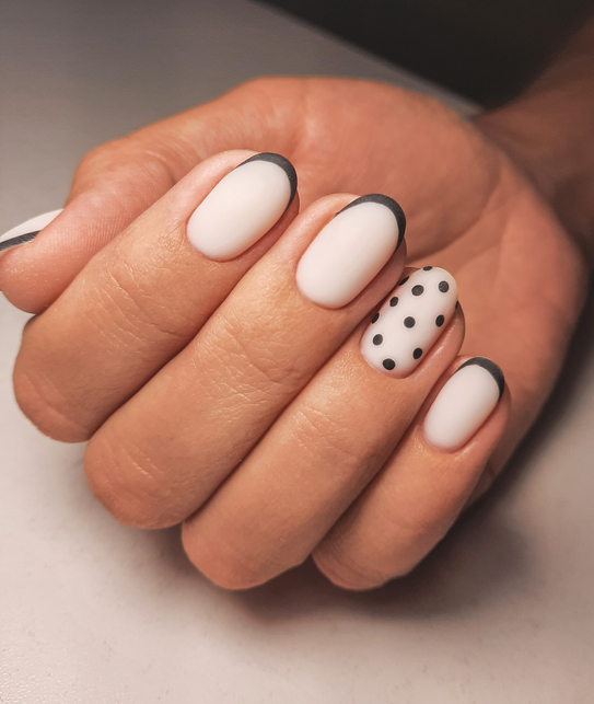 Black French tip and polka dot nails.