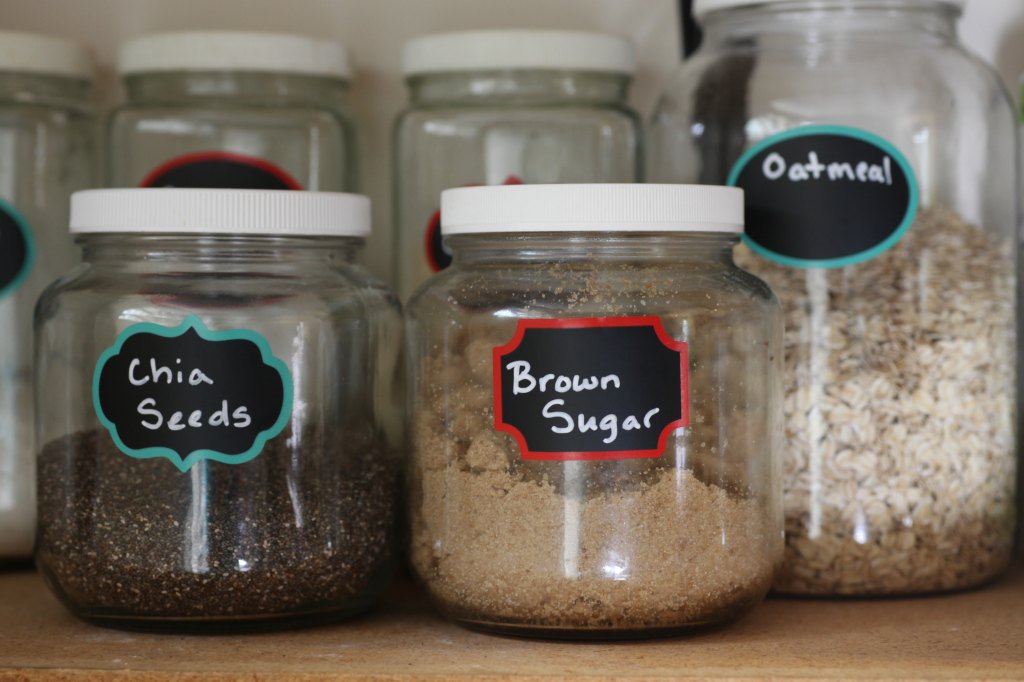 Labels on food jars in pantry.
