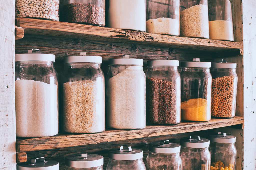 Dried beans and cereal stored in glass jars.
