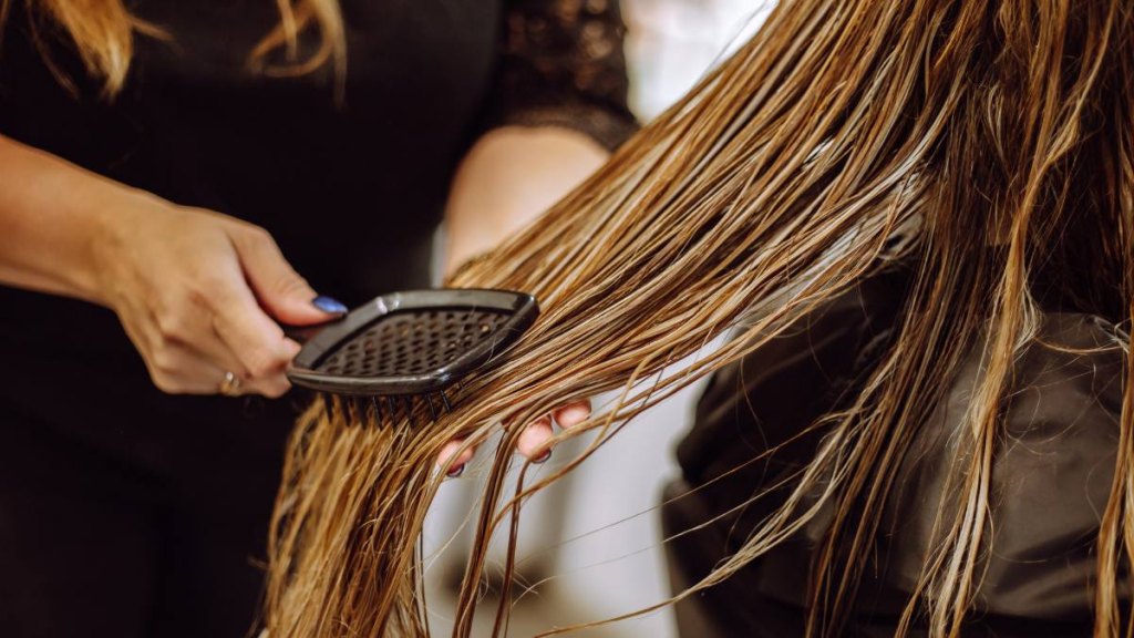 Hair being brushed from the bottom up