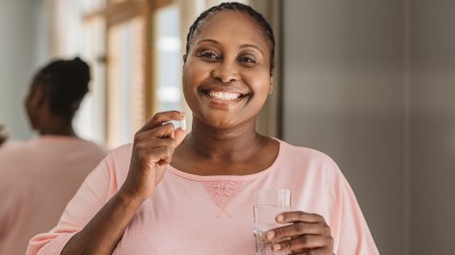 Black woman taking the best calcium supplement