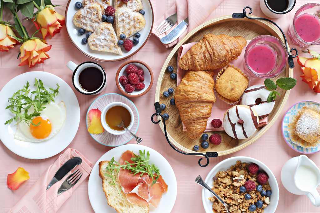 breakfasts foods on table with pink tablecloth