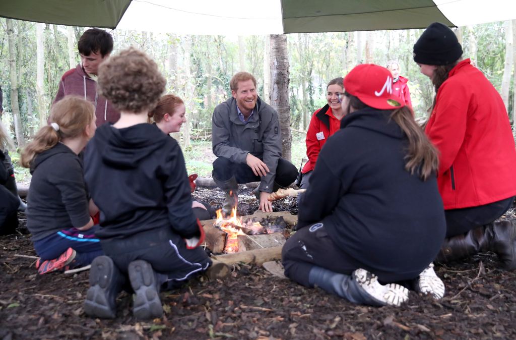 Prince Harry with kids at a campfire