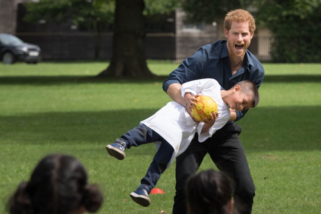 Prince Harry playing with child