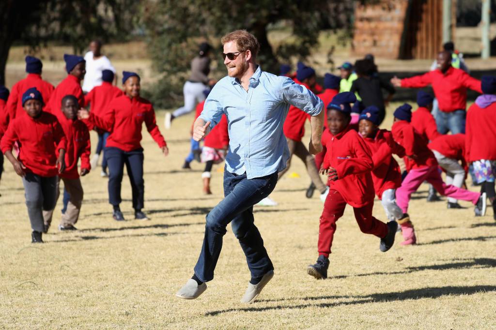 Prince Harry playing soccer with kids