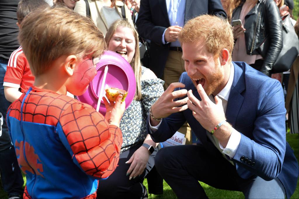 Prince Harry with a child dressed as Spiderman