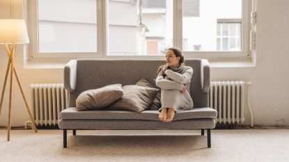 Woman sitting on couch looking sideways