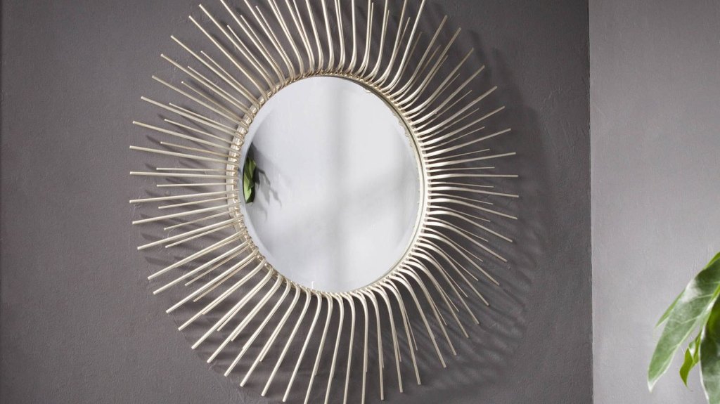 sunburst wall mirror on gray wall