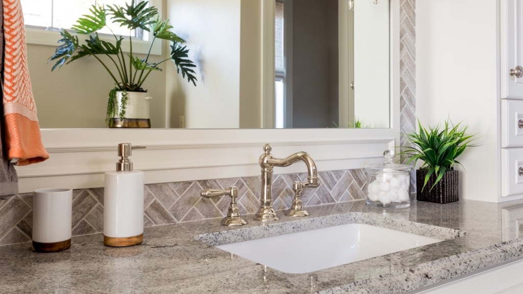 A bathroom countertop with a sink, which is a top germ hot spot in your house