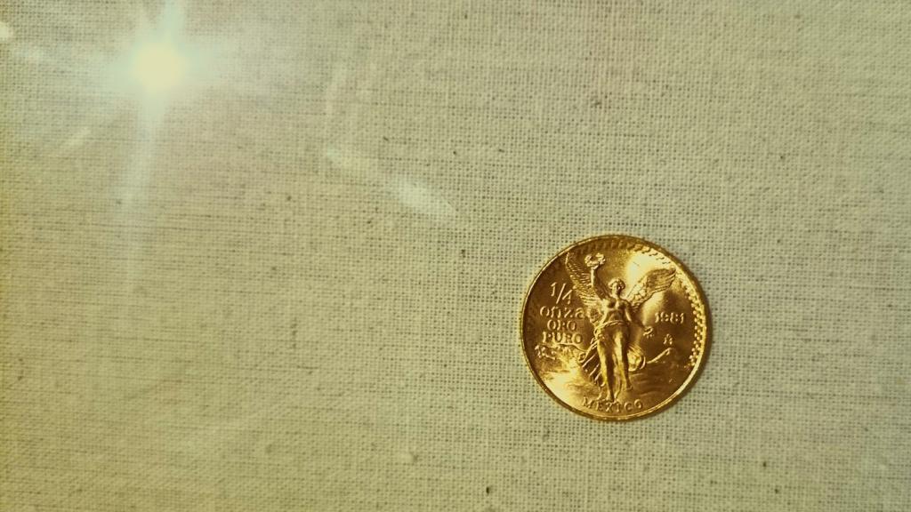 Directly Above Shot Of Mexican Coin On Fabric