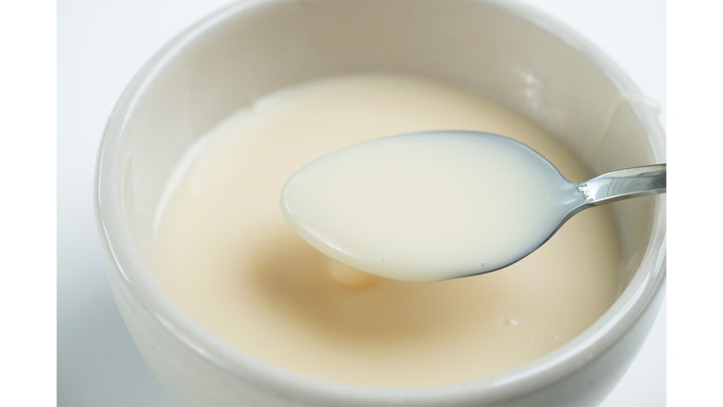 A bowl of evaporated milk for a recipe demonstrating how to make it