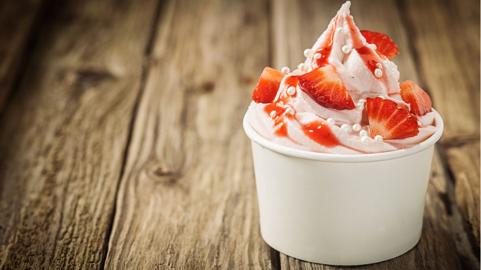 Frozen yogurt with fresh strawberries on top