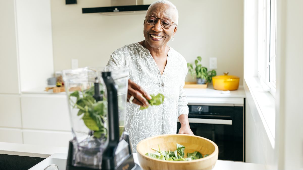 woman making healthy greens smoothie