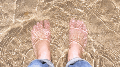 feet in the water at the beach