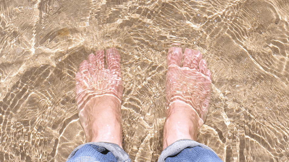 feet in the water at the beach