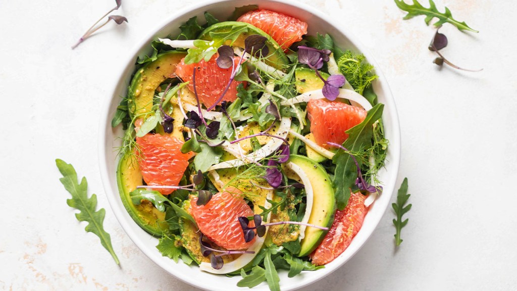Bowl of salad with grapefruit, avocado and arugula, perfect for grapefruit diet meal plan
