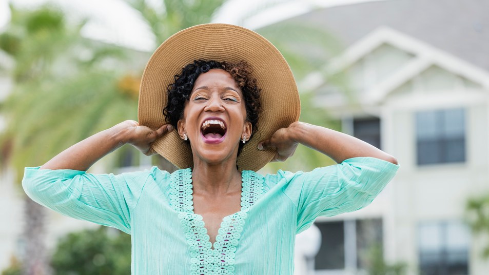 Black woman wearing hat and smiling