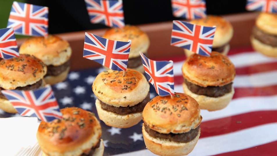Mini burgers with British flags on an American flag