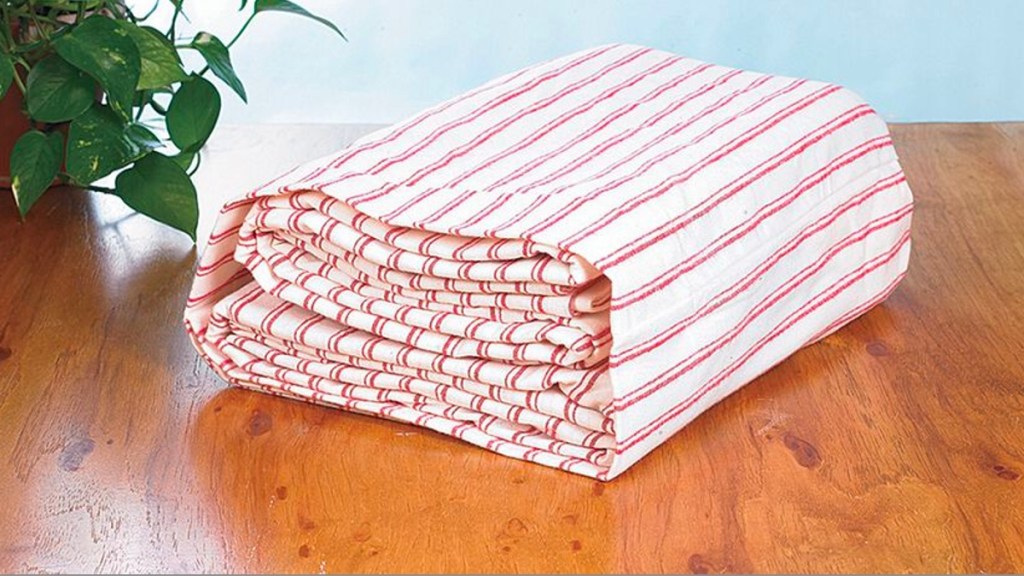 Sheets neatly stored in a pillowcase for linen closet organization