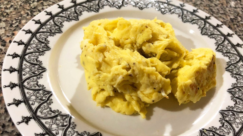 Plate with fluffy scrambled eggs