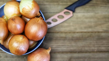 Bowl of onions with a knife