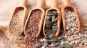Wooden spoons of sesame, flax, pumpkin and sunflower seeds used for seed cycling
