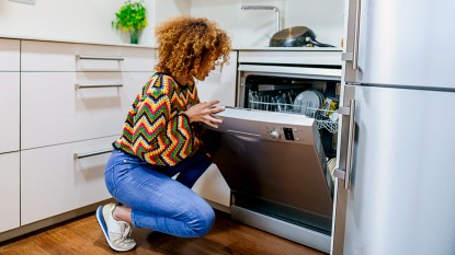 Woman looking in her dishwasher