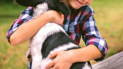 Little boy hugging dog