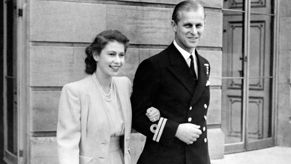 Young Queen Elizabeth and Prince Philip walking arm in arm
