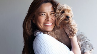 Smiling woman holding Yorkshire terrier