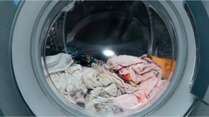 Wet clothes sitting inside of front-loading washing machine with door closed, How long can clothes sit in washer
