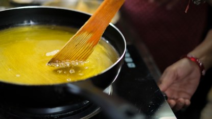 Wooden spoon in hot oil