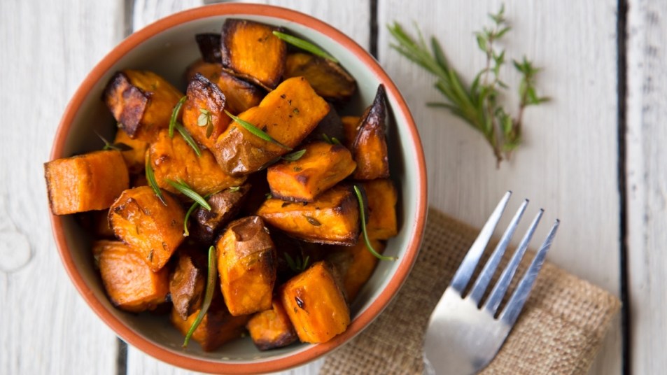 A diced, roasted sweet potato in a bowl, which has health benefits for women
