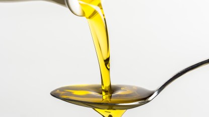 Olive Oil Being Poured Onto a Spoon