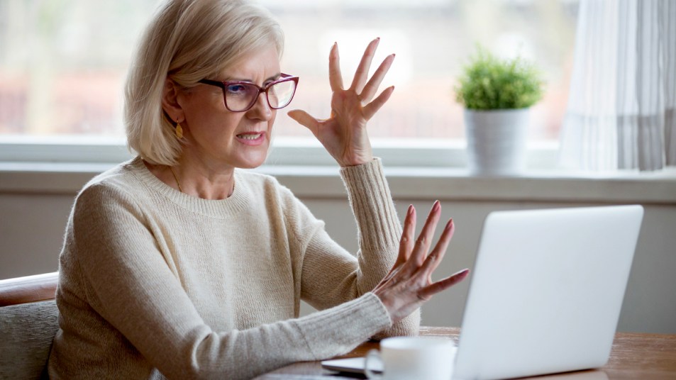 Woman irritated in front of laptop