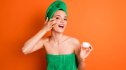 Photo portrait of women applying cream under eye from jar
