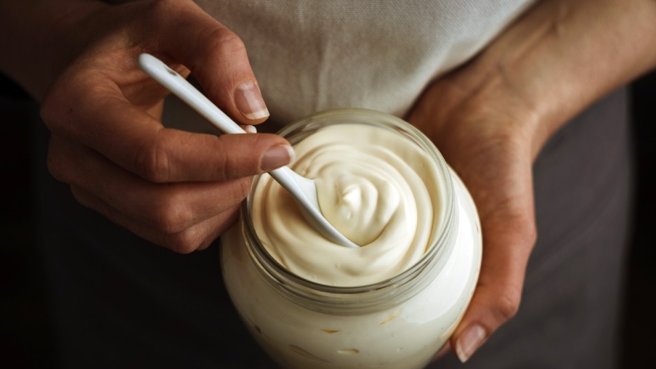Woman's hands with jar of mayo
