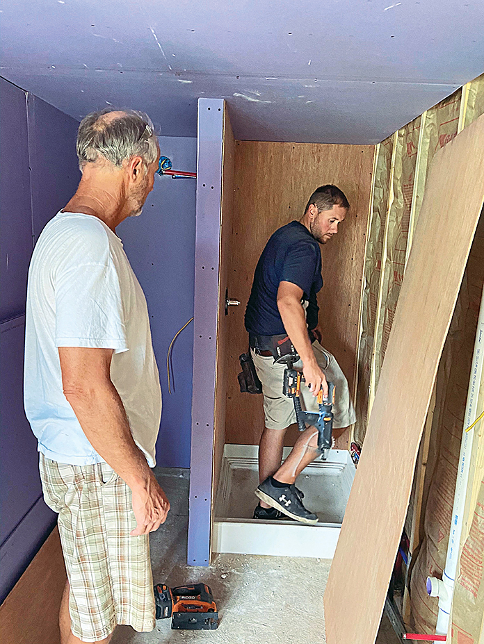 Contractors workin on Dorothy Mullins' bathroom