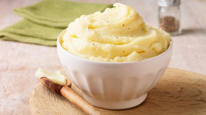 Mashed potatoes in a bowl with a spoon as part of a guide on why you can use it when making the dish