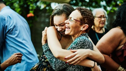 woman hugging niece at outdoor family gathering