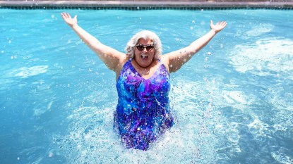 Woman splashing in pool