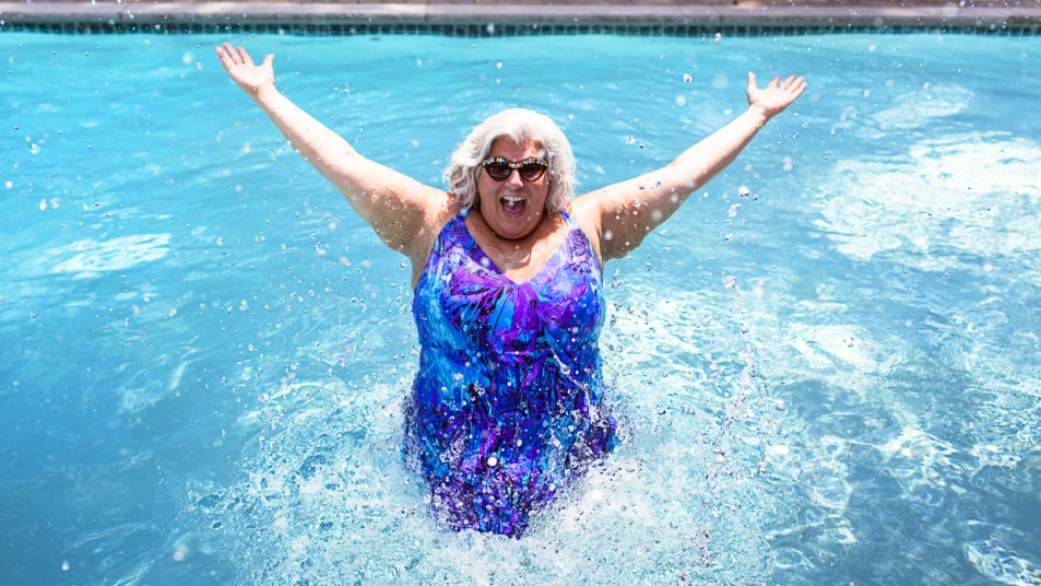 Woman splashing in pool